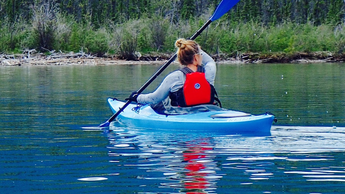Person paddling a blue kayak