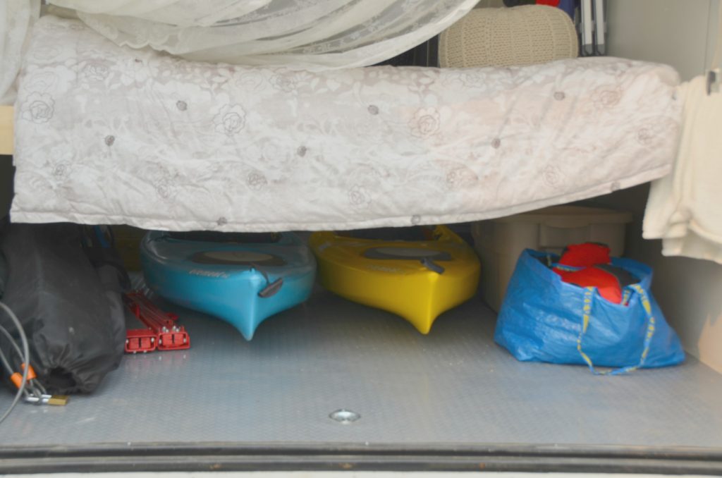 Kayaks and gear stored under the bed for transport.