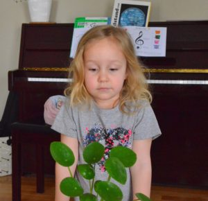 Young child looking solemn after zipping her song into her pocket