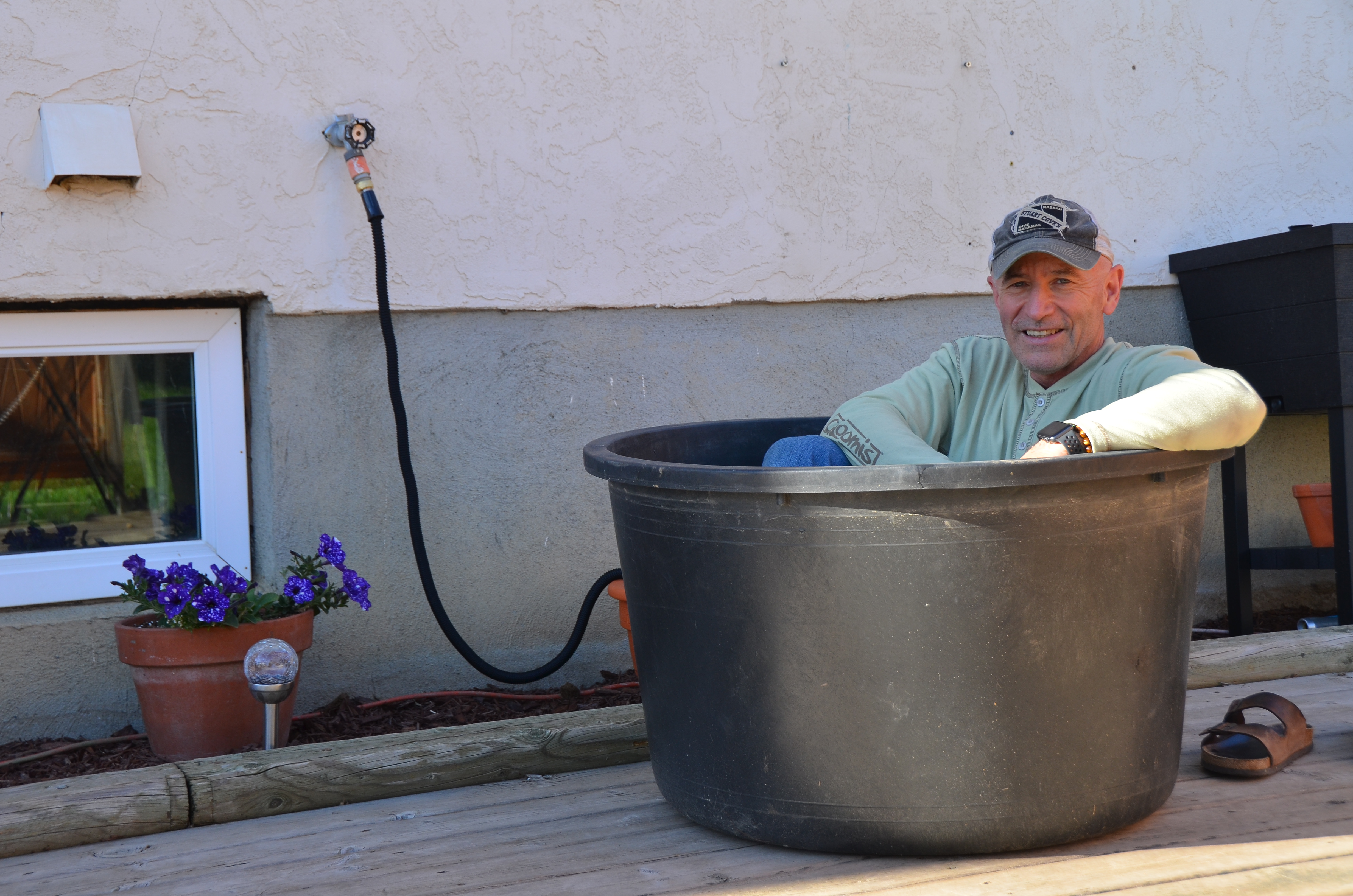 My good natured husband sitting in the rubber tub to showcase how we plan to use it as a portable hot tub.
