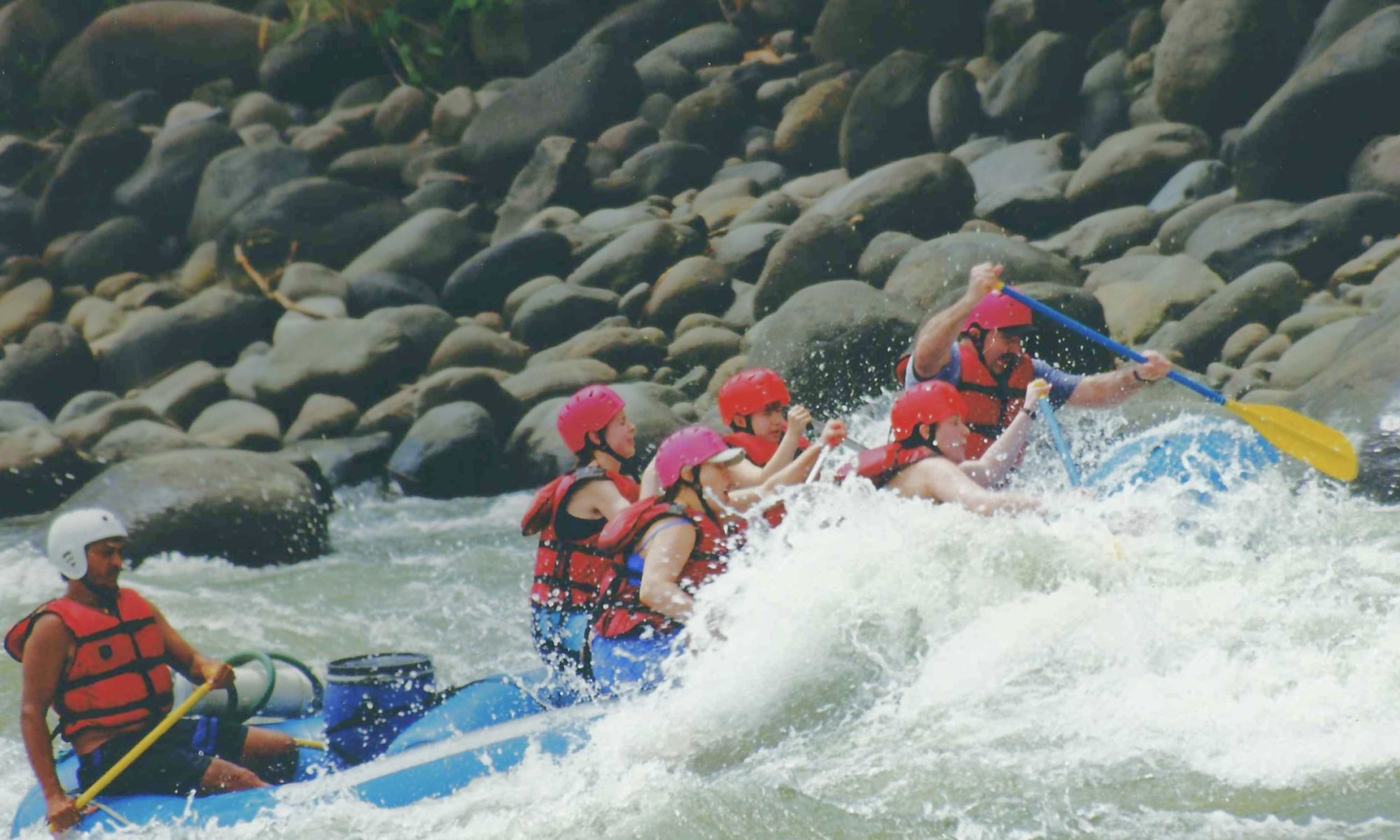 My family rafting through the rapids with our guide